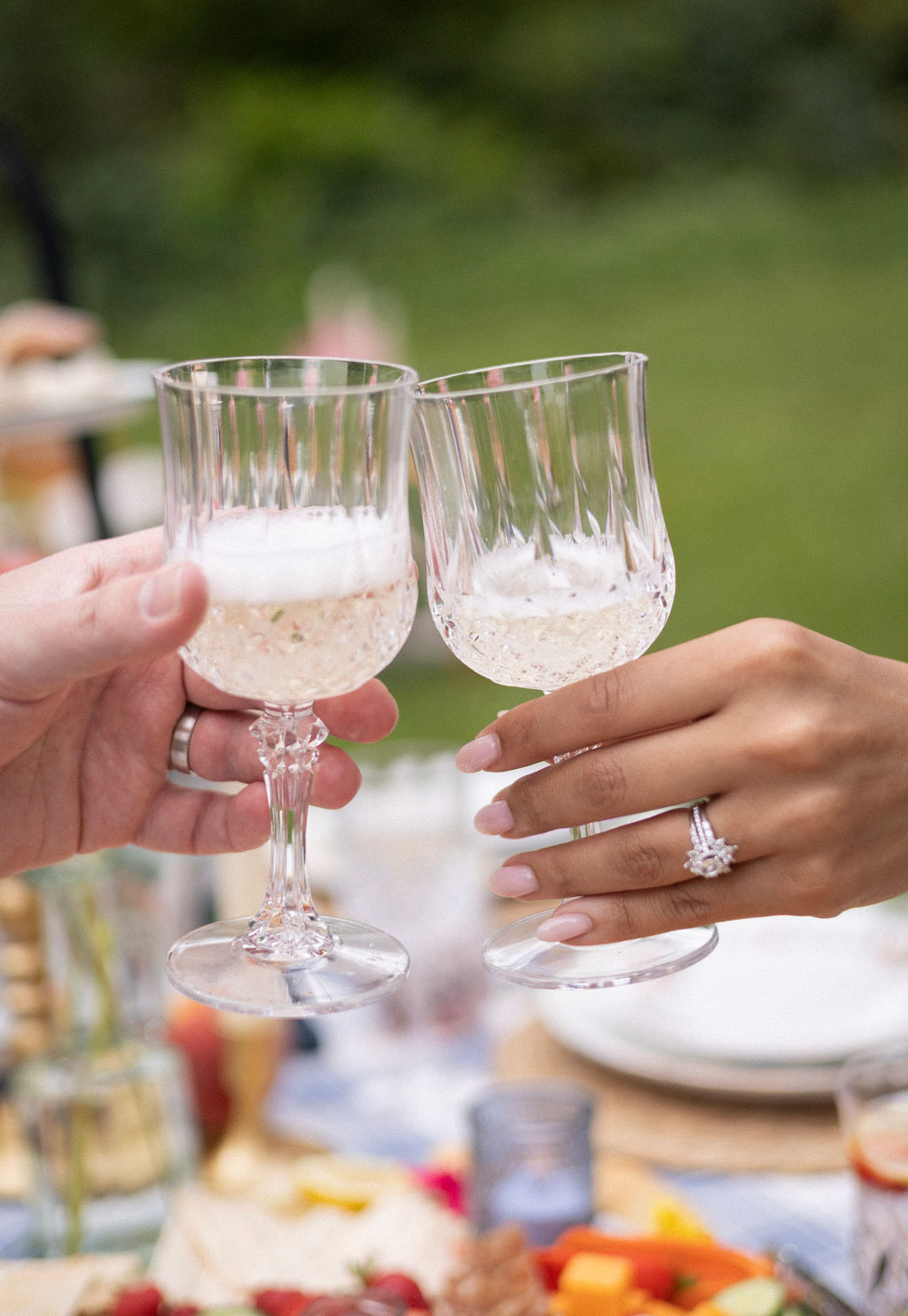 Two crystal glasses of Oregon sparkling wine touching in a toast