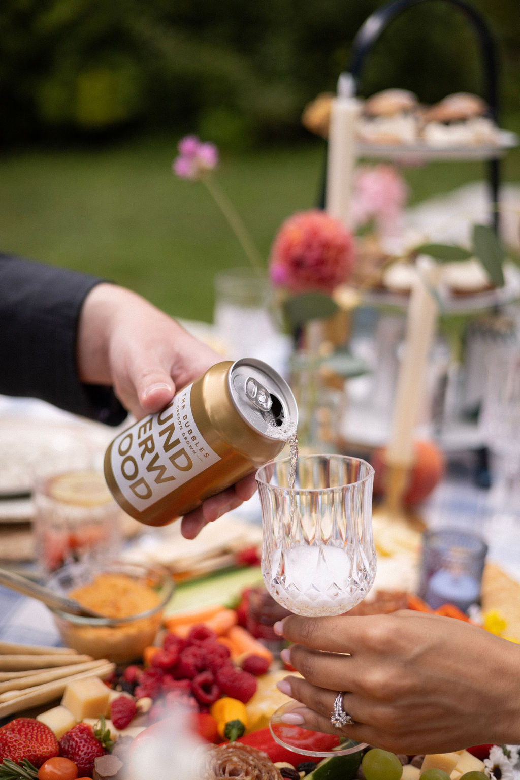 Oregon sparkling wine poured from a can into a cut crystal glass at the picnic table